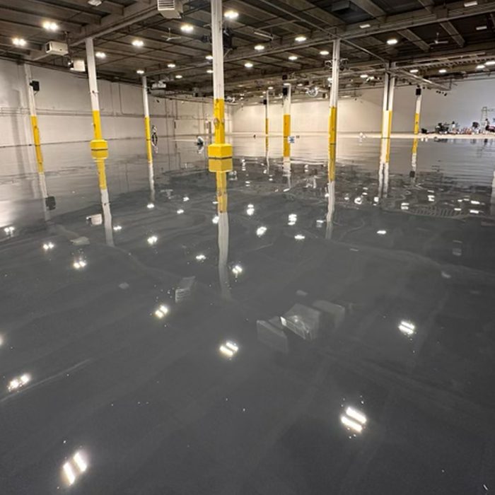 Dark gloss epoxy floor in a warehouse bay