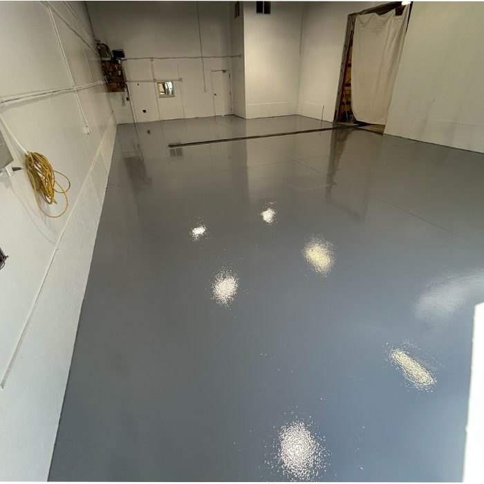 Solid grey epoxy floor in a finished garage